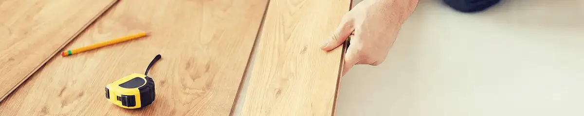 A professional installing wood flooring in Tempe, AZ