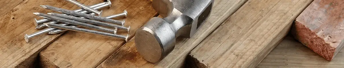 Hammer and nails on hardwood flooring boards in Tempe, AZ