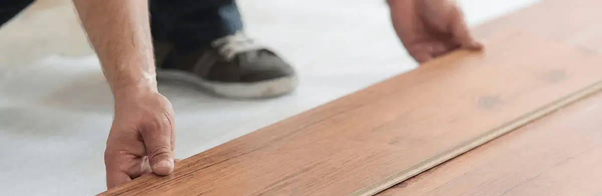 A professional installing laminate flooring in Tempe, AZ