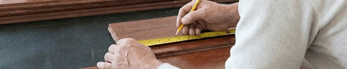 A professional installing wood flooring in Tempe, AZ